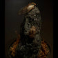 Insect on a textured rock with a dark background